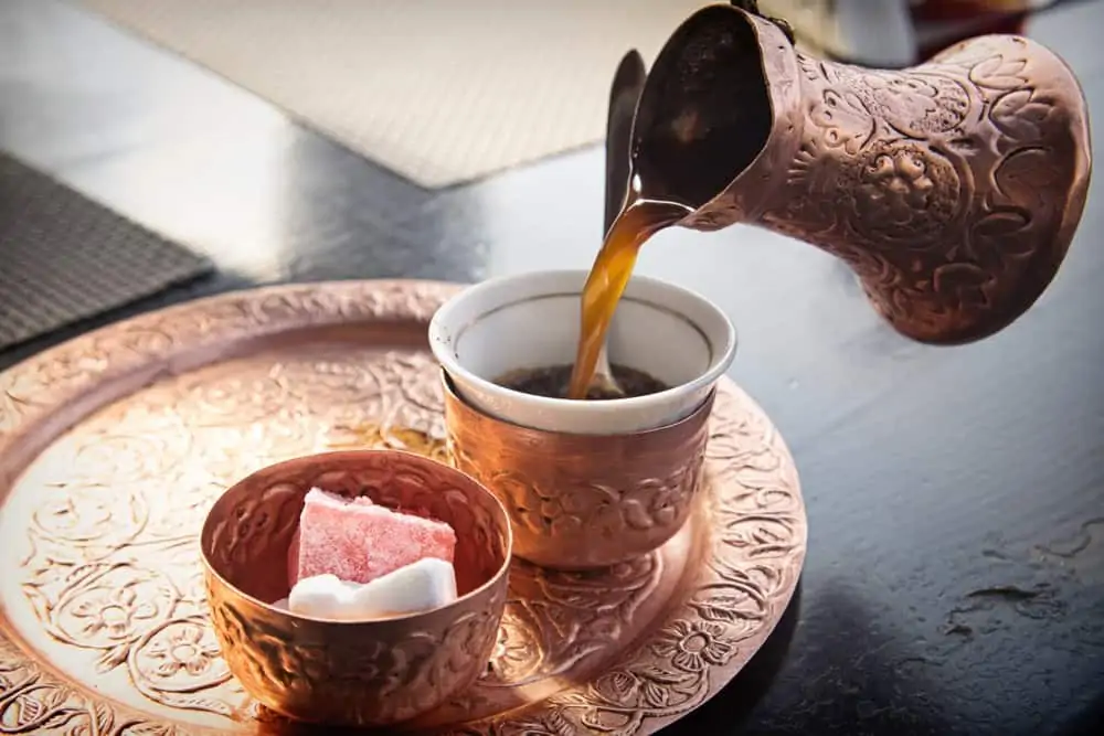Traditional Bosnian coffee served in copper džezva pot with Turkish-style coffee cup and rahat lokum